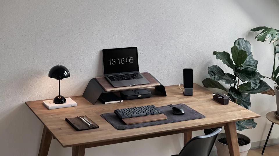 A laptop on a desk represents Windows devices; the photograph is not a Microsoft product image.